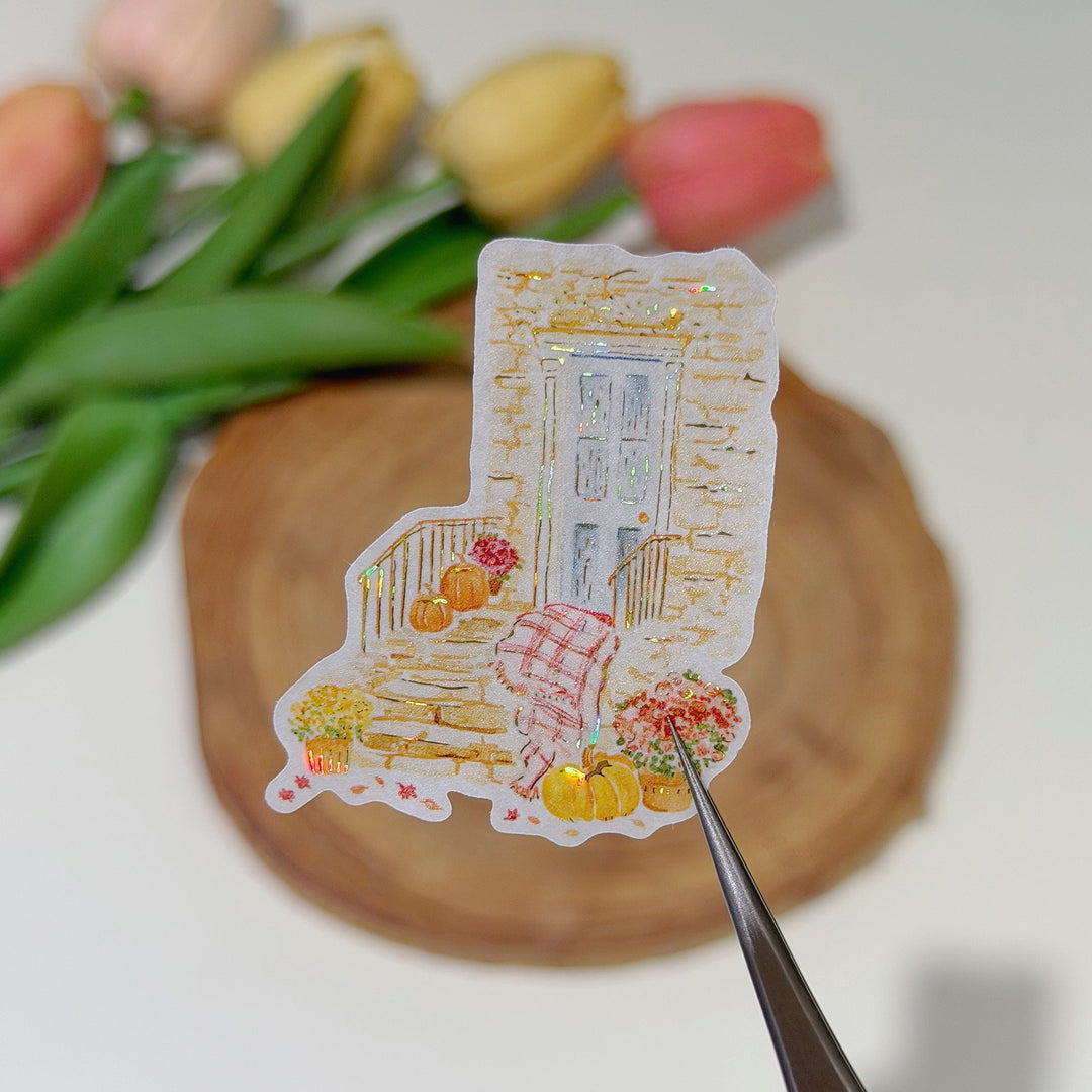 Tweezers lifting a pre-cut piece from The Washi Tape Shop Autumn Village Wide Washi/PET Tape