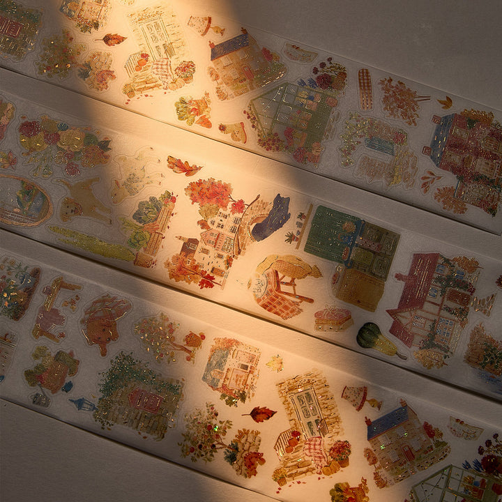 The Washi Tape Shop Autumn Village Wide Washi/PET Tape laid out in warm sunlight, showing the seashell gilded village details