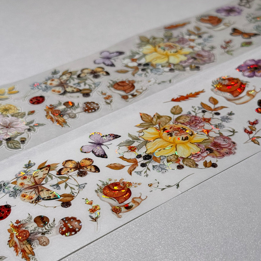 Strips of The Washi Tape Shop Golden Harvest Wide Washi/PET Tape laid flat with the rolls, showing the full design