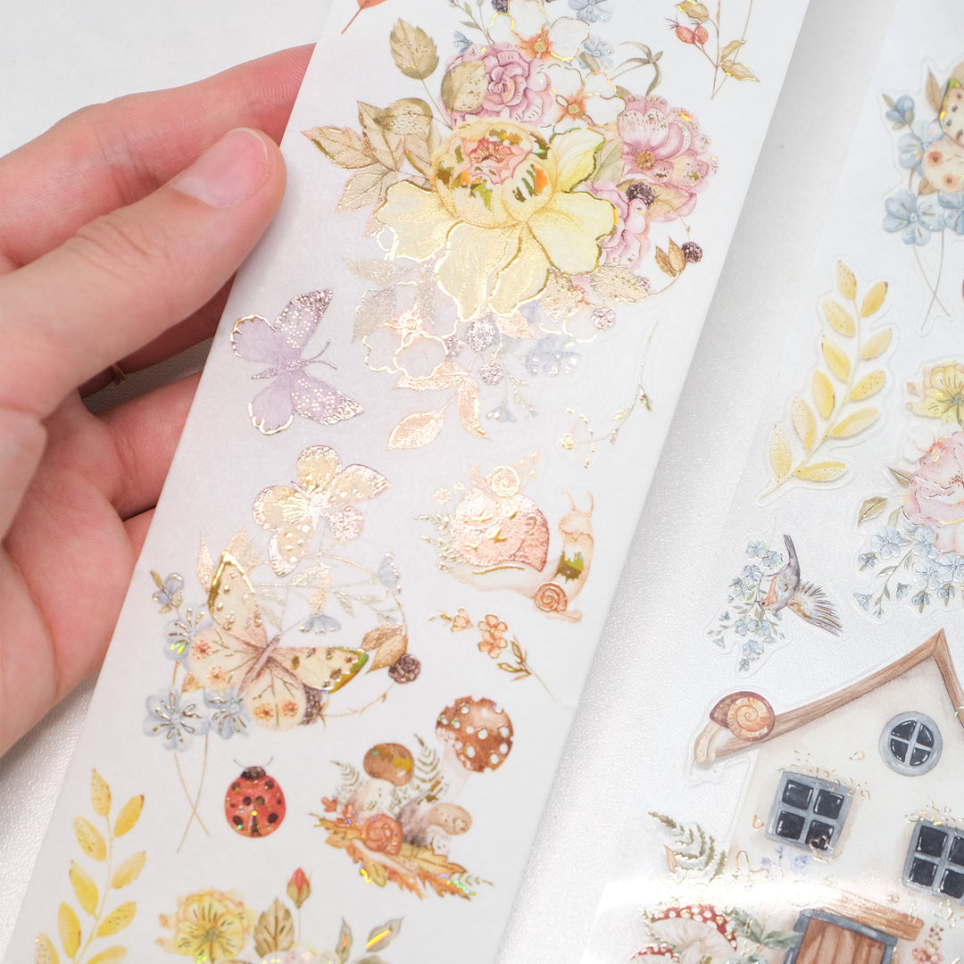 Hand holding the washi and PET rolls of The Washi Tape Shop Golden Harvest Wide Washi/PET Tape