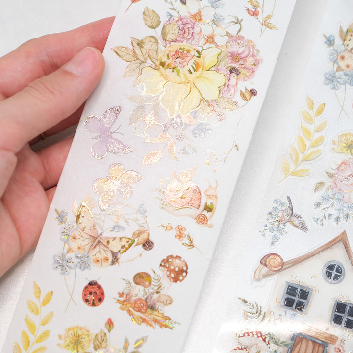 Hand holding the washi and PET rolls of The Washi Tape Shop Golden Harvest Wide Washi/PET Tape