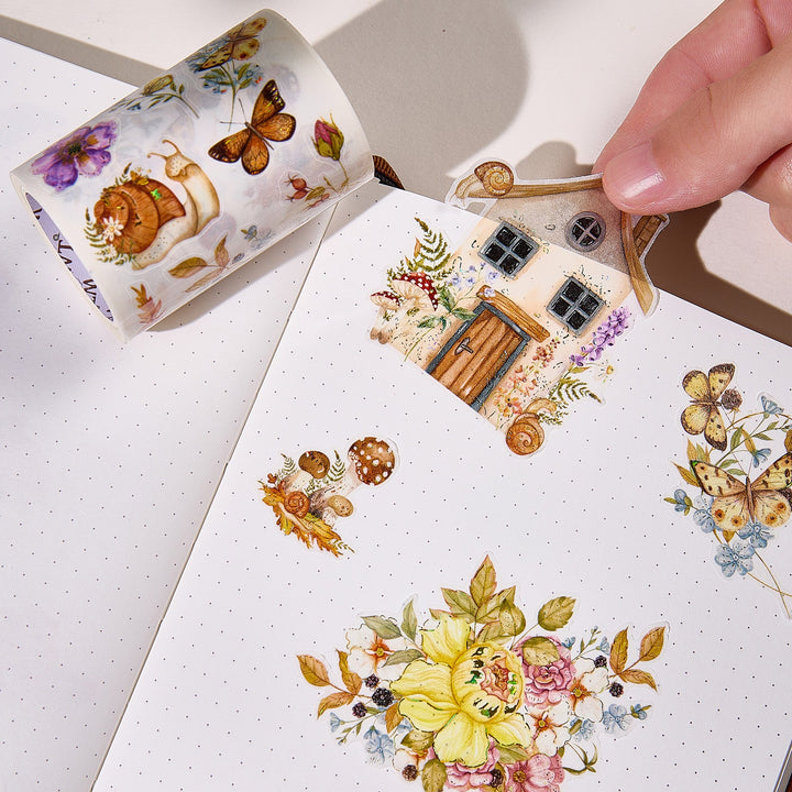 Hand peeling a pre-cut piece from The Washi Tape Shop Golden Harvest Wide Washi/PET Tape onto a journal page