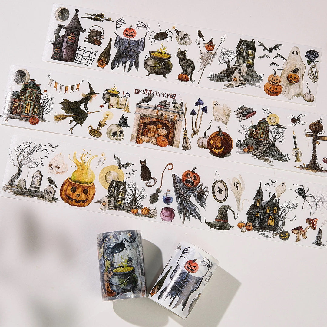 strips of washi tapes with haunted houses ad ghoulish themes laid out with the rolls next to them
