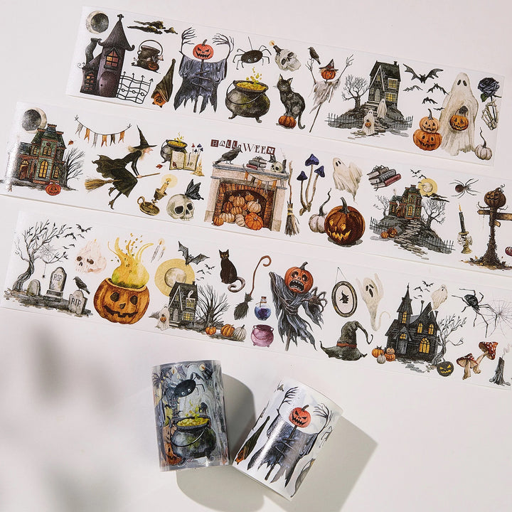 strips of washi tapes with haunted houses ad ghoulish themes laid out with the rolls next to them