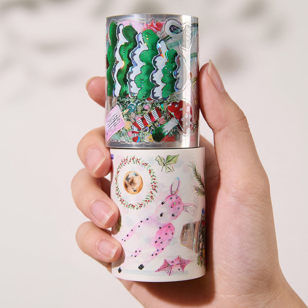 Hand holding the washi and PET rolls of The Washi Tape Shop Pink Frost Wide Washi/PET Tape