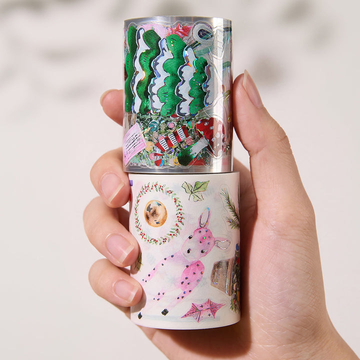 Hand holding the washi and PET rolls of The Washi Tape Shop Pink Frost Wide Washi/PET Tape