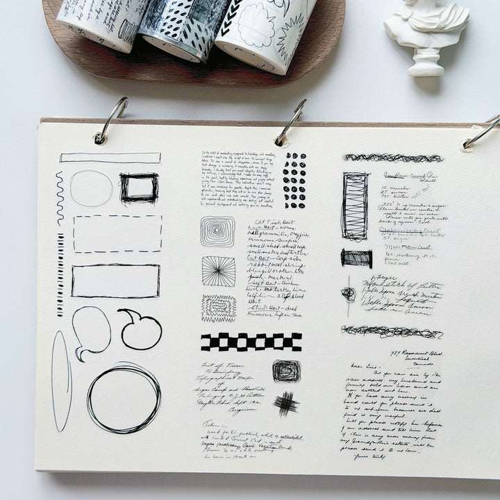 Washi and PET rolls of The Washi Tape Shop Speech bubbles Wide Washi Tape alongside the scribbled thoughts in a journal.