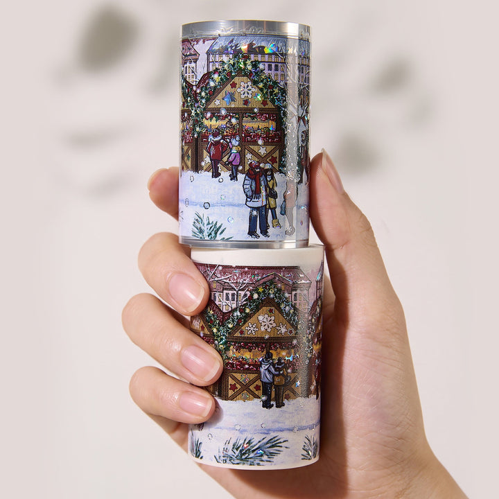 Hand holding the washi and PET rolls of The Washi Tape Shop Yuletide Glow Wide Washi/PET Tape