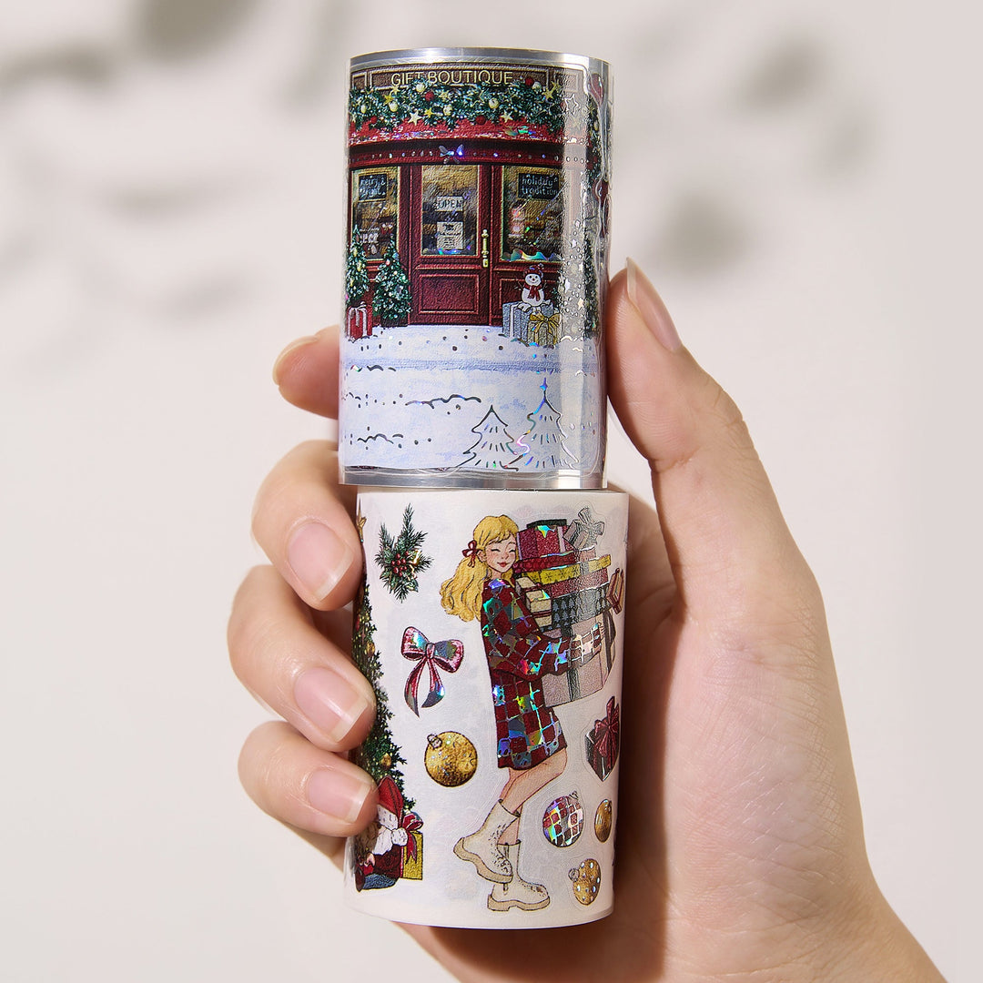 Hand holding the washi and PET rolls of The Washi Tape Shop Yuletide Village Wide Washi/PET Tape