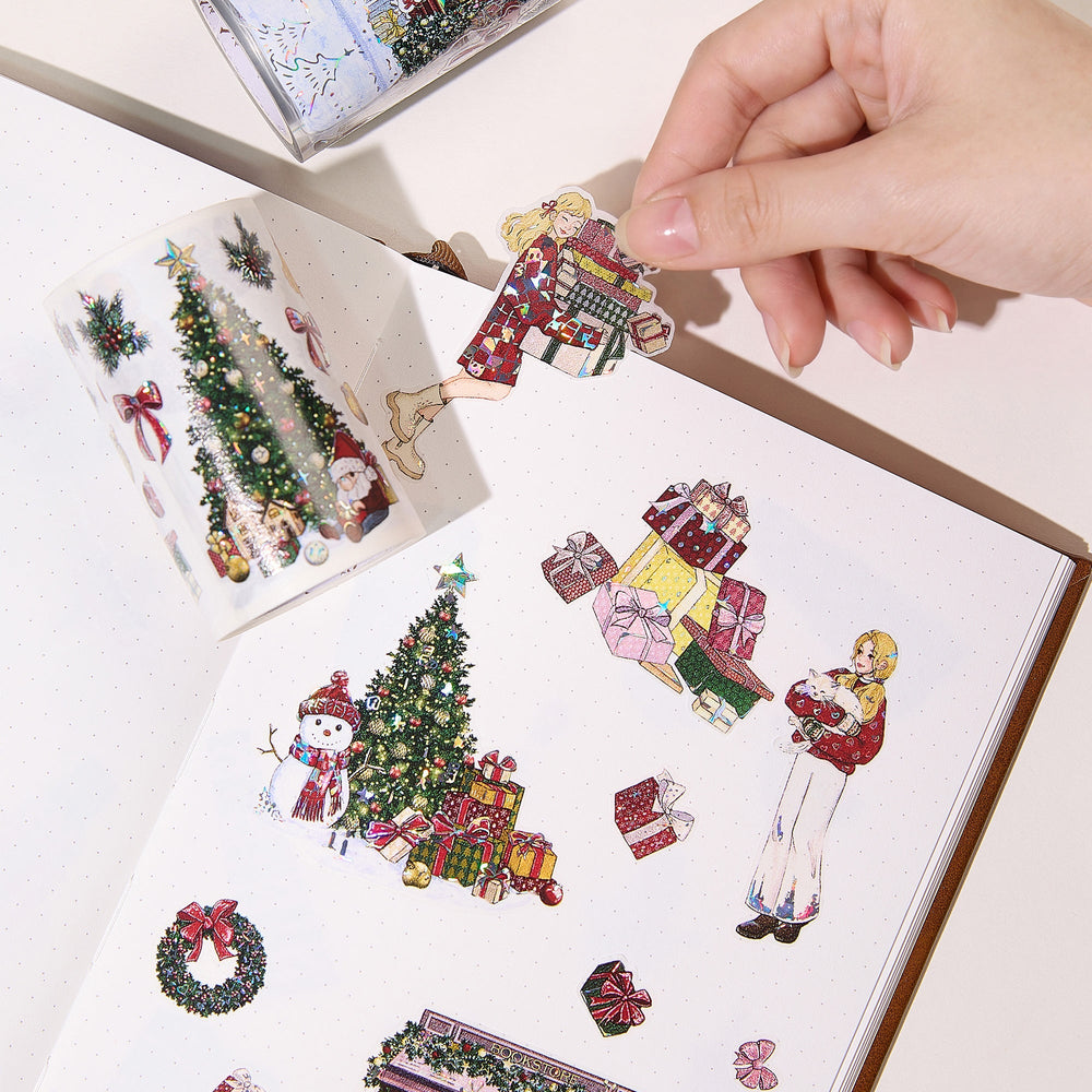 Hand peeling a pre-cut piece from The Washi Tape Shop Yuletide Village Wide Washi/PET Tape onto a journal page