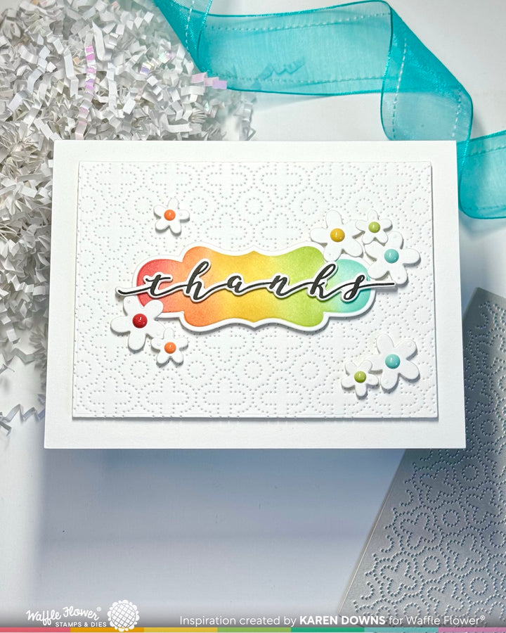 waffle flower Card with rainbow 'thanks' text and decorative elements on a white background