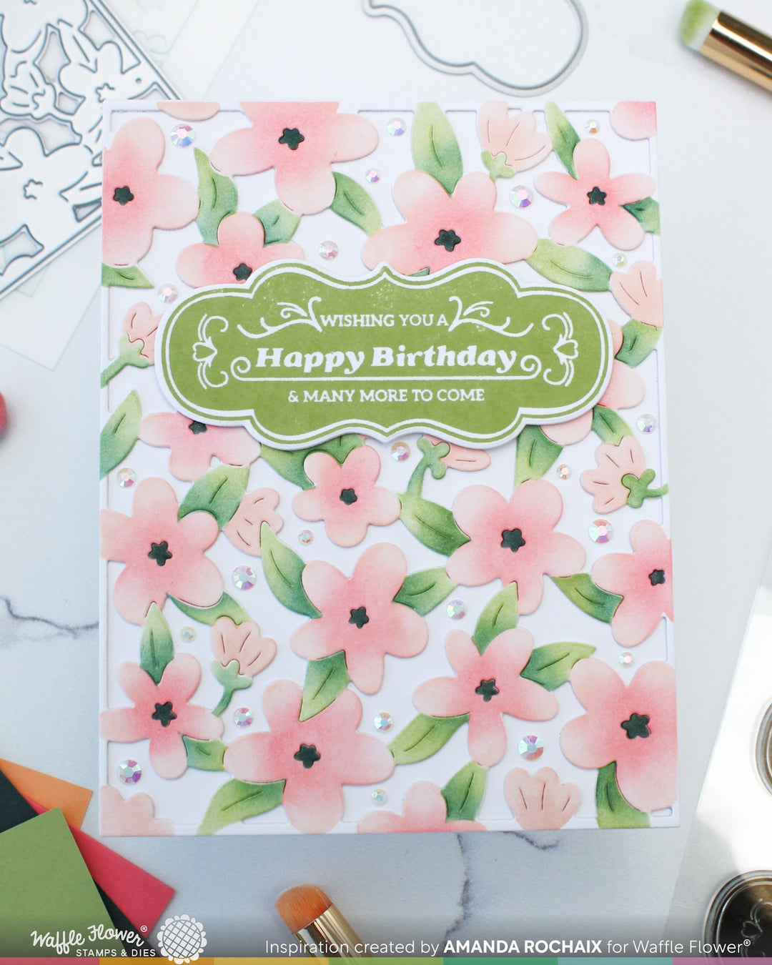 Floral birthday card with 'Wishing you a Happy Birthday & many more to come' text on a white background.