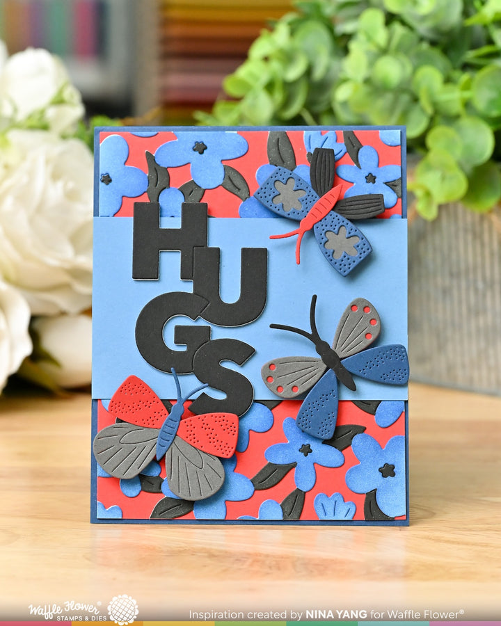 Overlapping hugs and mix and match butterflies, card by Waffle flower in blues and reds