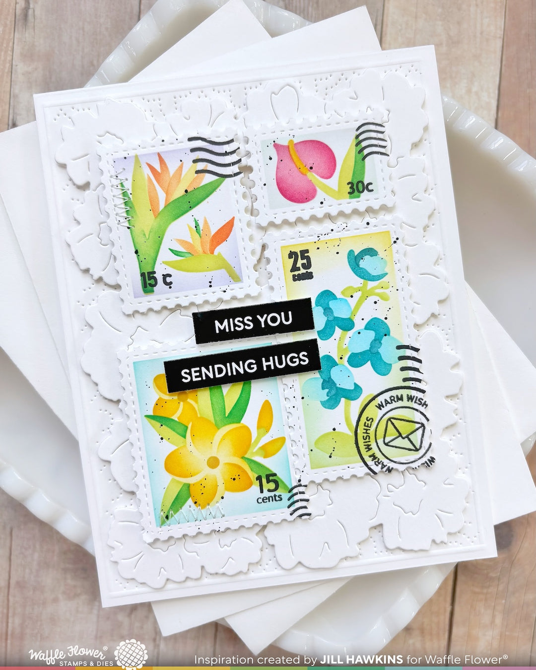 Card with postage stamp designs and 'Miss You' message on a wooden surface