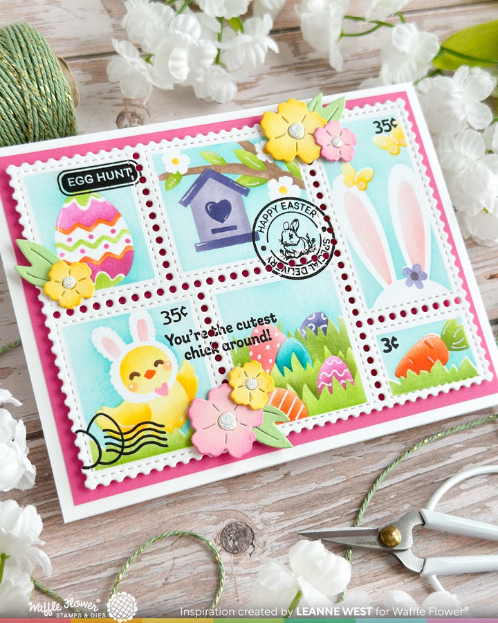 Colorful Easter-themed card with stamps and decorative elements on a wooden surface.
