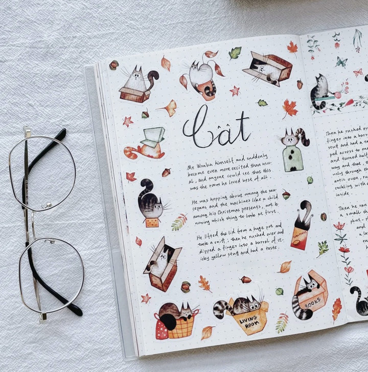 The Washi tape shop cat stickers on a journal spread