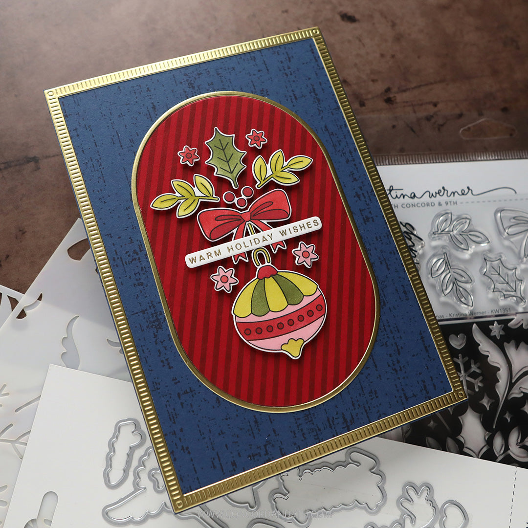 Concord & 9th Kristina Werner Ornamental Christmas Stamps — a navy card with a "Warm Holiday Wishes" ornament and floral panel on a red striped background.