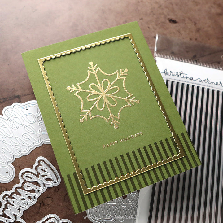 Concord & 9th Kristina Werner XL Basic Stripes Background Stamp — a green card with a gold-embossed snowflake and a striped border panel.