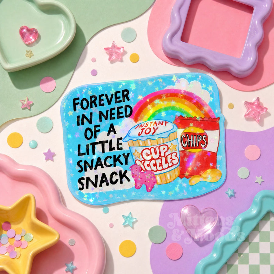 A square sticker with rounded corners featuring a colorful cartoon design. The sticker has a light blue background with sparkles, a rainbow, and says forever in need of a little snacky snack.