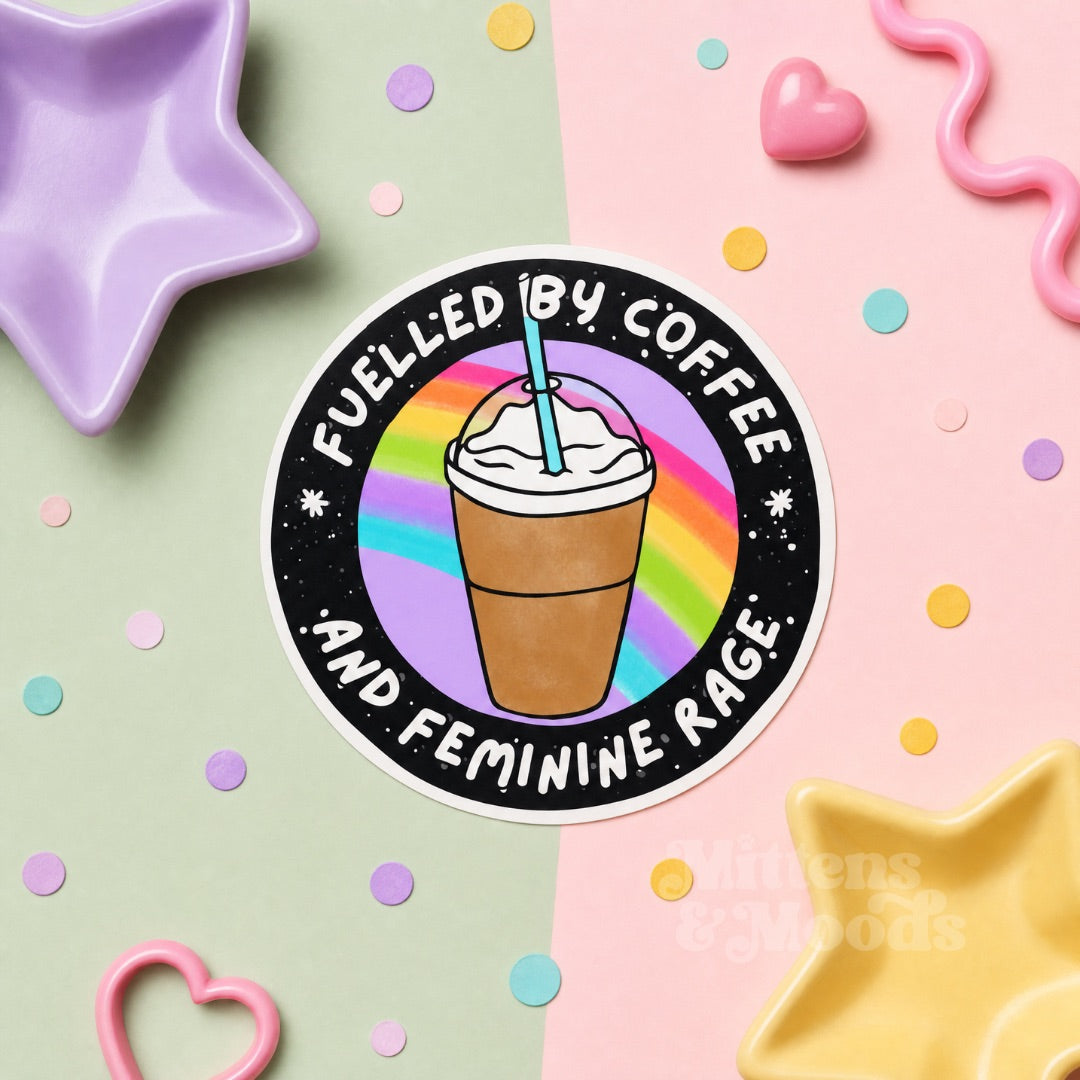 Sticker with iced coffee and text 'Fuelled by Coffee and Feminine Rage' on a colourful background.