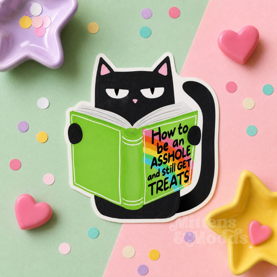 A die-cut sticker featuring a black cat reading a green book with the text 'How to be an ASSHOLE and still GET TREATS' on the cover, styled on a pastel pink and mint background with confetti and star-shaped dishes.