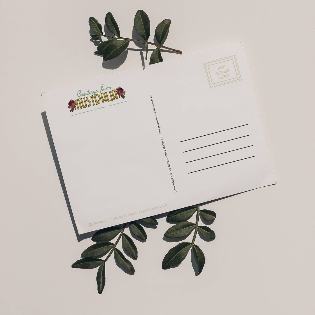Postcard with green leaves on a light background