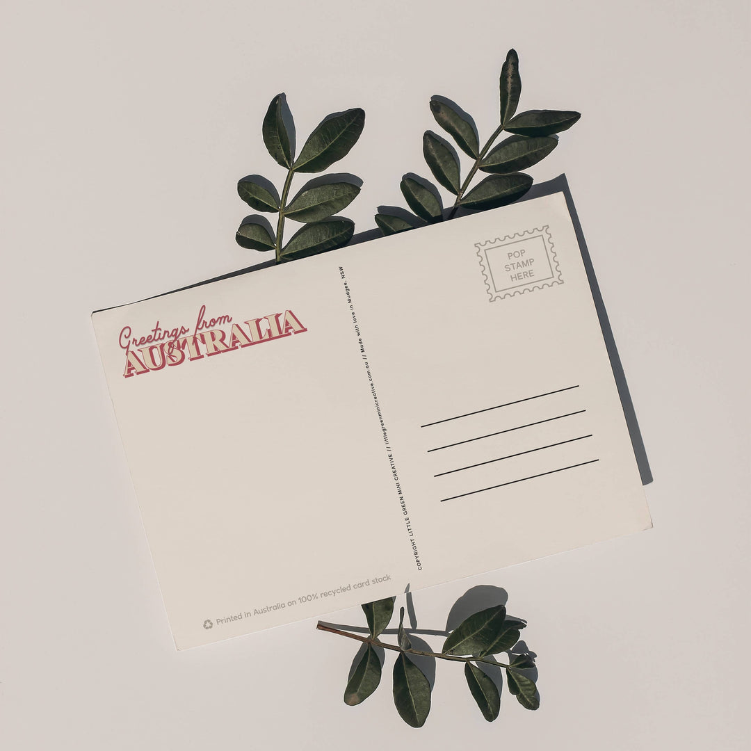 Postcard with green leaves on a light background
